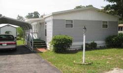 Large dbl wide manufactured home in Inlet Oaks Village, a very active 55 and older community, with beautiful moss covered oak trees, three fishing lakes, a clubhouse and swimming pool and lots of activities for residents who wish to participate. Located