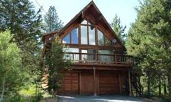 Sunny log home chalet in a quiet area set back off of Alder Creek Rd. Large vaulted living room, with wood ceilings and a full bank of south facing windows with mountain views. Easy level access to 2 car garage with workshop area and large separate