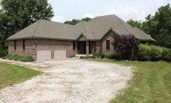 Large beautiful brickfront home, with 4 beds, 4 baths, walkout basement with additional family/rec room. All quietly situated on 15 m/l acres just outside of city limits and minutes from the county seat. Property has entire fencing with shelter and enough