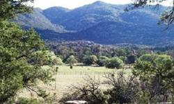 One of American Ranch's finest equestrian lots. This 4.12 acre lot sits just two lots from the National Forest entrance and fronts the seasonal creek with some of the most direct views of Granite Mountain in the community! Perimeter fenced with four rail