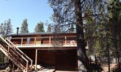 Cozy Cabin in the tree tops of Sunriver located on quiet tree-lined cul-de-sac close to Ft. Rock. Master and guestroom on upper level with greatroom and dining area. Beautiful tongue & groove ceilings and woodstove capture the true Sunriver cabin feeling.