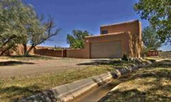This private adobe gated residence is located in between Santa Fe and Los Alamos. Featuring; great outdoor living space, a hot tub off of master bedroom as well as a completely enclosed property of .91 acres. An irrigation ditch runs through the property