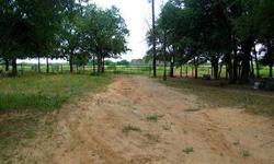 Fantastic location with unlimited possibilities! Great sandy ground, huge oak & pecan trees, and gorgeous well maintained coastal field. Several, barns, stalls, and pens w water to all. Lots of pipe fencing, road frontage on 2 sides, and complete privacy