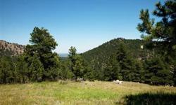 Beautiful 2.88 acre Pine Brook Hills lot with views of the city and plains, plus meadows, rock out croppings and stands of trees. With a choice of lovely building sites surrounded by mostly rolling terrain and privacy, this is one of the few remaining