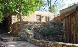 Just off Palace Ave, up a dirt road, past an ancient stone wall with embedded fossils is a beautiful casita. Charming, quaint and authentic are just a few words that come to mind. This house is everything you'd find in a Santa Fe style coffee table