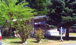 Well mzintained mobile home in Weaver Creek Mobile Home Park. 2 bedroom, 1/4 bath with walk-in closet in master bath. Lovely and peaceful fully fenced yard with lawn, trees and flowers and trail to East Weaver Creek. Newer roof and heating and A/C