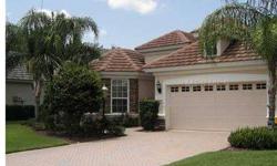 Upgraded model by "Neal Builders" in the Country Club of Lakewood Ranch with serene lake views. This beautiful stone and stucco home features a oversized ceramic tiled great room with built-in entertainment center. Seperate formal dining room, large den