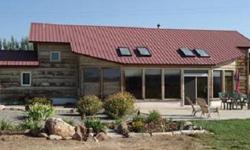Passive solar earth shelter home on 6.61 irrigated acres. The home has tile floors, a sun room with trombe wall and ice block construction in half wall for heat storage. Very energy efficient. Open great room concept with vaulted ceilings, skylites and 6