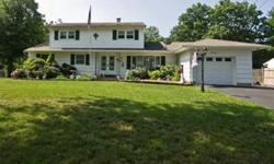 This fantastic Colonial is on almost half an acre of land & offers 6 bedrooms, 2.5 baths, a garage, light/pickled hardwood flooring, walk-out basement, great kitchen w/crown moulding, recessed lighting, white cabinetry featuring stained glass & peninsula