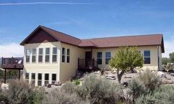 Custom "Systems Built" home takes full advantage of the views of the valley and surrounding mountains from all the huge windows and deck. This raised-ranch style home may be accessed from either level with the possibility of separate quarters on the lower
