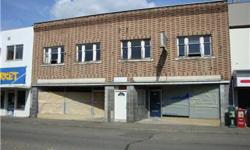 Fountain District Building. A two story masonry structure locaed on a 50 x 100 lot. Each floor has 2588 square feet. Main floor is dividedinto two retail bays. The second floor has two apartments. Attached at the rear of the building is a single level