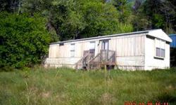 If you're looking for a mountain home with some unrestricted land for horses or a garden, check this one out. 2 bd/1 ba mobile home not far from Murphy with 1.5 acres at at good price.
Listing originally posted at http