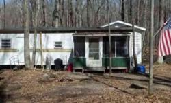 Older Trailer with large shed, trail access on 10 acres with creek.
Listing originally posted at http