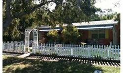 Adorable Dunedin Historic area home with Keywest flare, picket fence, metal roof, newer windows, wood burning fireplace, bonus room, with a beautiful sun room overlooking tropical backyard, Outdoor stand alone enclosed screen room with slate floor awaits