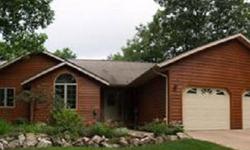 This comfortable ranch style home features cedar siding on the front and accenting vinyl finishing the homes exterior. You enter the home into an entry that gives access to the homes open living area with neutral decor, wood burning fireplace and bright