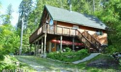 Cedar Brae Chalet offering three levels of cabin living. Upstairs master loft with beautiful views of the lake. Main floor ~ Kitchen, bedroom & bath with large deck, picture windows, pine accents, stainless kitchen & cement counters. Lower level has