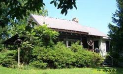 Wagon Wheel Farm - tucked into the Monroe County countryside, this 78 acre farm has a number of wonderful features! The 3-4 home is part log for that wonderful country flavor and comes fully furnished. Several outbuildings on the property give you plenty