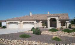 Beautiful custom home in great neighborhood located in the Hualapai Foothills. 1.84 acres with panoramic views, boat deep garage,newer 2009 water well producing 100+ gallons per minute. Fantastic kitchen with alderwood cabinets, granite counter tops,