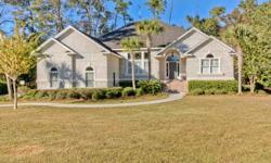 Pristine, move in ready custom home on beautiful Oak Grove Island. Enjoy an afternoon drink on the new screened porch with vaulted ceiling and views of the 15th green. Large great room opens to a sunroom and the screened porch. Formal dining room with 12'