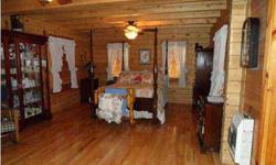 JIM BARNA LOG HOME ON 5 ACRES IN MADISON CITY LIMITS. The home is natural wood through-out. Huge kitchen with custom cabinets, solid surface countertops, and gas range. Family room has vaulted wood beam ceilings and rustic rock fireplace. Large master