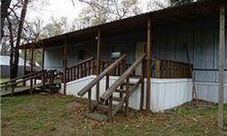 Bring your boat and water toys to this great little get away. Lake Texoma is just a hop, skip and jump away. Move in ready to this cute single wide mobile home. This home sits on 2 fenced in corner lots. Wood covered deck has a wheelchair access. Nice