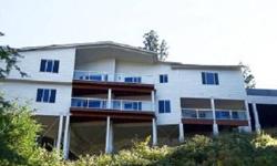 Panoramic views of Liberty Lake itself & surrounding hillsides from the entire eastside of this home. Three trex decks & perched on a hillside. Granite slab kit; central vac; 6-panelled doors; granite baths & granite laundry rm; whole house surround