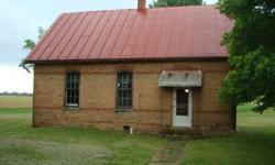 Being sold "As Is" Seller will do NO inspections or repairs. This old brick school house was built in 1896 and is in good condition. Wood floor are in good shape. Bricks need some tuck pointing. There is county water available, there is a septic tank,