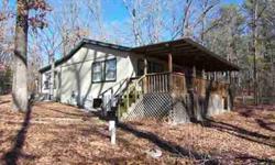 Great weekender or started home close to Lake Cypress Springs. Open and light. Huge sunroom is warm and inviting and has possibilities for other uses. Relaxing covered deck. Beautifully treed lot.Listing originally posted at http