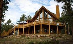 Perfect mountain log home! Unobstructed Pikes Peak views. Updated home with a rustic feel. Large master suite with 2 sided fireplace, 5 piece bath with walk-in shower & jetted tub. Country kitchen with hand carved cabinets and slate counter tops. Vaulted