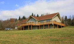 Spectacular home with wraparound deck secluded on 69 acres with beautiful view of the valley. Living room offers cathedral ceiling and custom windows that create plenty of natural sunlight. Living room and kitchen are enhanced by a double sided gas