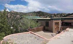 This solar home is different than the rest. Built into the Sunlit Hills south of Santa Fe and clearly inspired by its surroundings, the 4 bedroom, 3 bath has views and light with simple clean lines, large windows and pleasing interiors. The multi-level