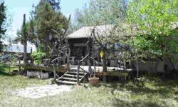 You wil love the rustic, country charm this property offers. The newer home features wood laminate flooring, two bedrooms and 1 3/4 bathrooms, including a master suite with steam shower. The cabin was built in 1912 and still features the original