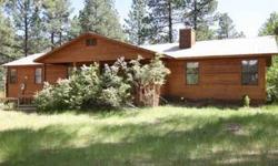 This cedar-sided home is set on over 4 acres in Los Ranchitos with room for all of your toys. This home has separate bedroom suites on both sides of the home. The living room has a wood-burning fireplace and large windows bringing in the forested views.