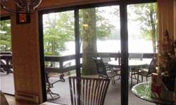 Lakefront home sits privately off road on fully landscaped lot with an amazing waterfrnet view. Hardwood floors , fireplace, and large deck overlooking lake. Lots of glass to enjoy the spectacular water and sunsets. Very well maintained and updated .