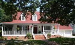 Traditional home with plantation shutters, approx 1150 sqft of covered porches including screen porch and a deck, elegant crown molding elegantly embrance the interior, shimmering wood floors, a spacious family room with a traditional brick fireplace and