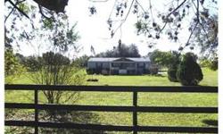 Down a private lane you will find this beautifully maintained 1997 Double wide mobile home on 1.7 acres, in a rural setting with nice elevation between Dade City and Zepjyrhills. Fenced for horses, no deed restrictions, and no fees. Deck front and back,