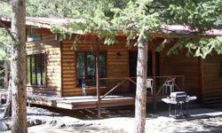 Custom Colorado Mountain Home tucked in the trees along a channel of Chalk Creek. The exterior is log siding and the interior woodwork is exquisite. An oversized, attached two car garage includes plenty of work space. A small log cabin on the property can