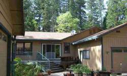 Custom 4+ bedroom, 2 1/2 bath home located across from the Empire Mine and close to Union Hill School and downtown Grass Valley. This large, well maintained home features a spacious updated kitchen with Corian counters and custom cabinets opening into a