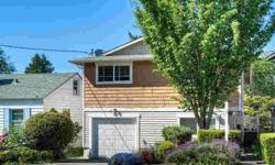 This West Seattle house exudes a love for life, surrounded by lush greenery & plenty of daylight. Entertain in gourmet kitchen w/ granite counters, stainless steel appliances & travertine flooring. Bathroom off main adorned w/ red marble counter & custom