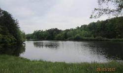 ATTENTION HUNTERS, FISHERMAN, FARMERS AND/OR DEVELOPERS!!! Beautiful well laying property with approximately 3400 ft of paved state maintained road frontage and approximately 12 +/-acres private mature watershed lake complete with covered shed and