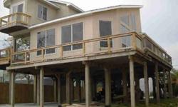 BAY HOME WITH LARGE WRAP AROUND DECKS AND WATERVIEW FROM EVERY ROOM * OPEN FLOOR PLAN * LIVING ROOM WITH 2 STORY CEILING * SPACE FOR 6 CARS UNDERNEATH HOUSE * ROOF 2009 * NO DAMAGE TO HOUSE BY IKE *Listing originally posted at http