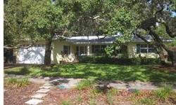 Charming in Belleair with a wonderful front porch set with pavers and a white railing. It has great curb appeal! This open and spacious floor plan welcomes you as you enter this lovely home with hard wood floors, updated eat-in kitchen, custom wood cabi