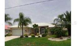Beautiful canal front home in Punta Gorda Isles with gulf access. 10,000 lb boat lift with 2 docks. Updates include newer kitchen w/cherry cabinets and granite counter tops. Newer tile flooring throughout home. Hurricane shutters. Heated pool. A great pla