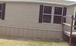 Great find!! 4 bedroom, 2 bath manufactured home on over 2 acres of treed land! This home has a really pretty kitchen, spacious and inviting, with wood laminate flooring, an abundance of counter space and a center island/breakfast bar. This open floor