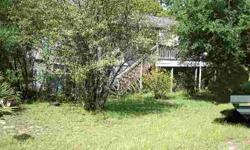 Nice Jim Walter-style home on two lots that abut the Ocala National Forest with public access to Big Lake Kerr approximately one mile away. Lower level has been enclosed, has a half bath, and could easily become additional living area. Upper level has two