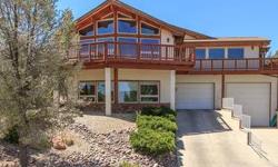 Warm & inviting home with long range views to the north and Tribal Land to the south. Very bright and open floor plan. Large mastersuite and Library/Media room.
Features in kitchen include acrylic cabinets, corian counters, maple flooring & double oven. 2