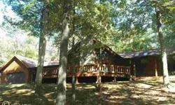 SUPERB LOG HOME w/ LOFT situated on 5 acres surrounded by MATURE TREES. The entire setting is serene. The floor-to-ceiling STONE FIREPLACE is riminiscent of a ski cabin. EXPOSED BEAMS, HUGE LOFT, GOURMET KITCHEN, full-length DECK add to the beauty and