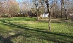 We have almost 2 acres of wooded, full of nature property. The home is an all brick ranch with hardwood floors, a great room but needs help. This home can either be re-habbed or its a great area to build new. New homes are going up all around. The home