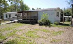 3 bedroom 16 x 80 mobile home with 4 lots, nice 10 x 10 deck with 10 x 14 roof over it plus ramp, 10 x 12 utility shed. New carpet in hall and living room 3 years ago. New dishwasher 4 years ago, and new septic in 2005. (Mobile home on two lots, other two