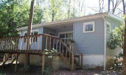 Level lakefront with western exposure and quiet deepwater cove headline this well priced property. Modest cottage with public sewer and well make this one of the best values on the market. Includes sight plan for future improvements. Listing agent and